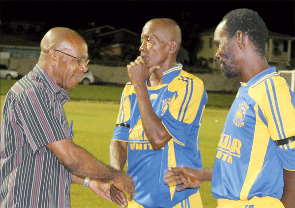 Image of Parliamentary representative for Soufriere Harold Dalson meets and greets the players. 