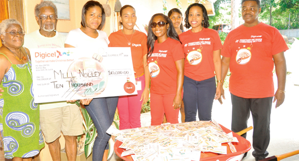 Mell Nolley with his wife and Digicel team members.