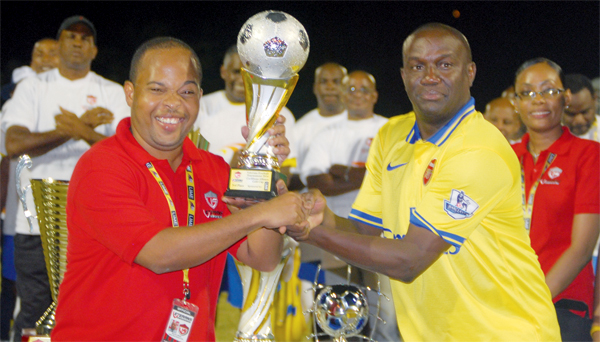 (Right) BTC Captain Tennyson Glasgow receiving the third place silverware from a representative of St. Lucia Insurance Alliances Limited. [Photo: Anthony De Beauville]