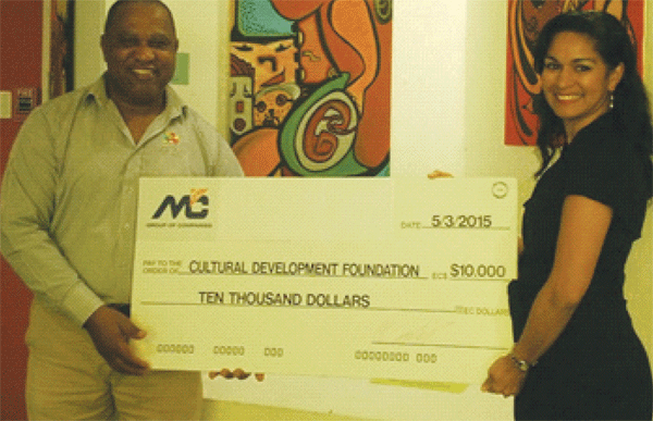 Mrs. Marella Devaux, Group Marketing Manager of M & C Group of Companies presenting the donation to Mr. Petrus Compton, Executive Chairman of the CDF.