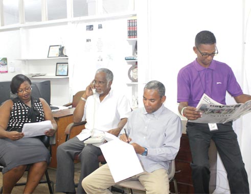 Image of Mr. Guy Ellis (second from left) in discussion with Editorial staff. Left to right: Rochelle Gonzales, Anthony De Beauville and incoming Editor Mr. Stan Bishop. 