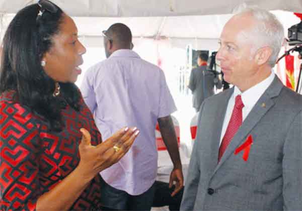 Health Minister Alvina Reynolds converses with Scotiabank Saint Lucia Country Manager, Philip Cross. [Photo: Stan Bishop]