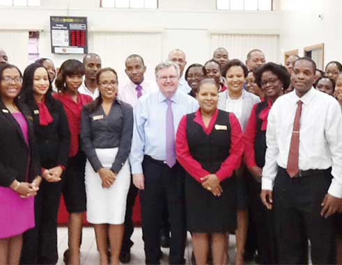 Image of FirstCaribbean CEO, Rik Parkhill (centre) with employees at Bridge Street Castries.
