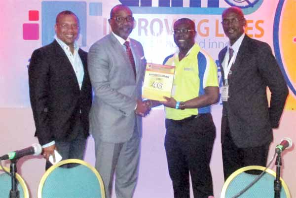 ECTEL Chairman presents a copy of the ECTEL Electronic Communications Review to the Minister for Telecommunications of St. Martin Hon Claret Conner. L-R - Mr. Giovanni King, Chief Operating Officer, Bureau of Telecommunications and Posts, St. Martin, Hon Claret Conner, Ectel Chairman Mr. Isaac Solomon, ECTEL Managing Director, Embert Charles