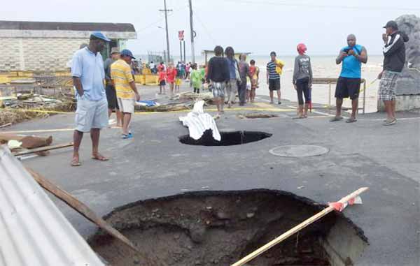 Sunken holes in the road next to the capital main market caused by Storm Erika.