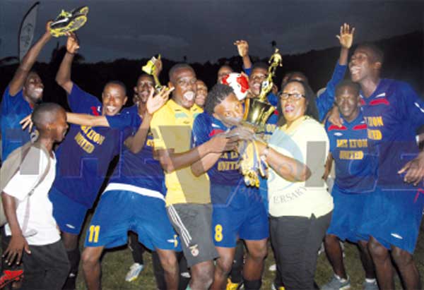 Celebration time for Aux Lyons United as EC Global Insurance Manager Anne Marie Herman presents the championship trophy. (Photo: Anthony De Beauville)