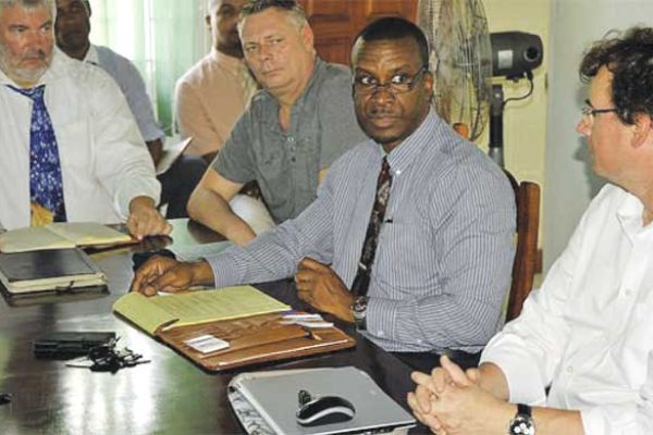 WASCO CEO Vincent Hippolyte (centre) discussing the de-silting project with stakeholders.