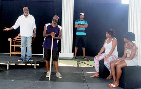 Alvin Hippolyte (far left) and Kennedy "Boots" Samuel (second from left) rehearsing their lines at Samaana Park last Saturday. [Photo: Stan Bishop}