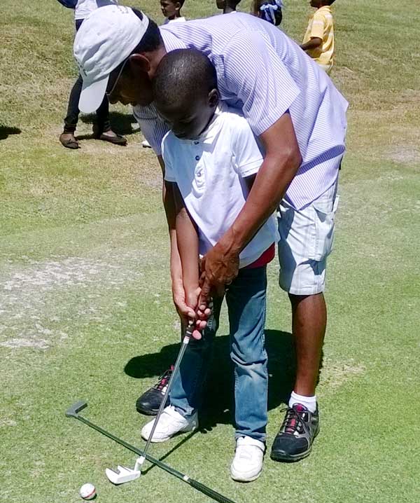 Image: Pro golfer Timothy Mangal with one of the young and aspiring golfers.(PhotoL SD)