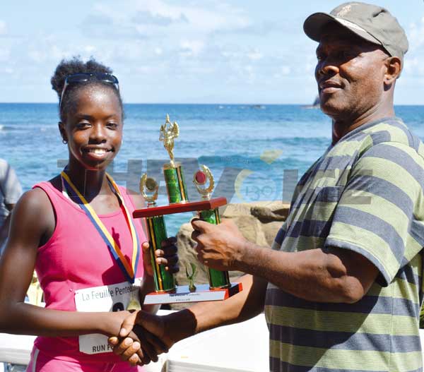 ThomykaValcent receiving her 1st place trophy from Pastor Lennox Maxius. (Photo Anthony De Beauville)