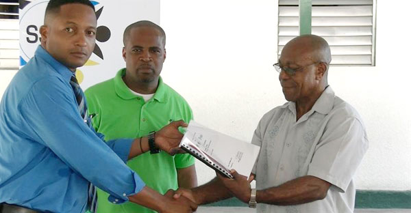 Image of Dalson (right) receiving plans for the project