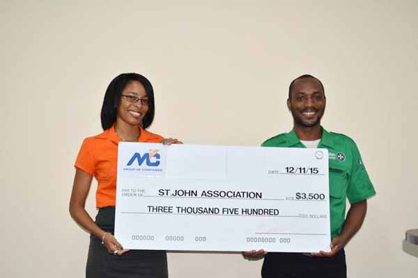 In photo from left to right: Ms Fern Wilson, Marketing Coordinator, M&C Group of Companies presenting a cheque to Mr Glen Wilson of St. John Saint Lucia.