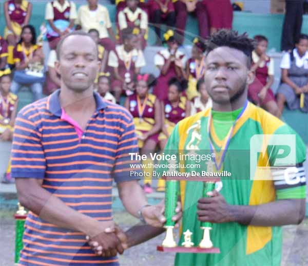Image: (L-R) Youth and Sports officer Dane Magloire presenting SALCC captain No. 5 JoshwaPropere with the runners up trophy in under 19 football. (PHOTO: Anthony De Beauville)