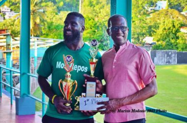 Mon Repos skipper Christian Charlery displays prize trophy with PM Pierre.