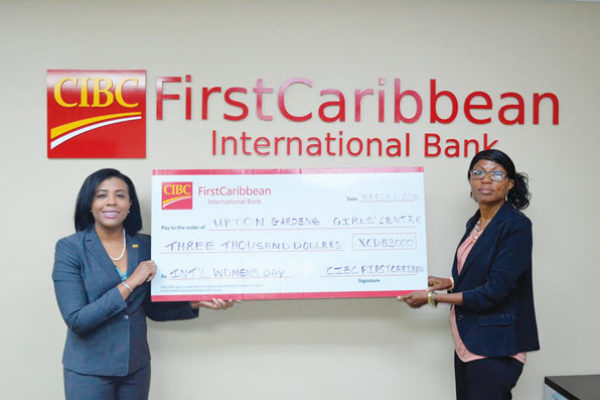 Image: Country Manager Ladesa James-Williams presents cheque to director of Uptown Girls Centre