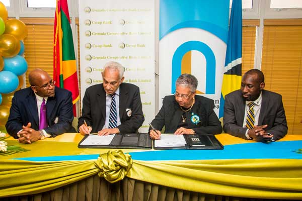 Image: Dr. Gardner (second from right) and Andy Delmar (right), Managing Director of 1st National at the signing.