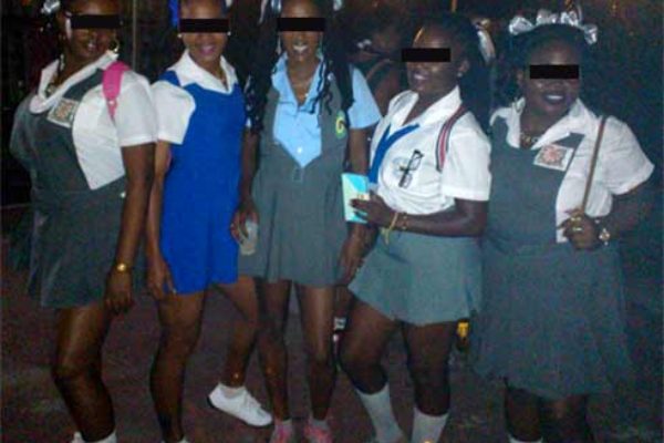 Image: Party goers show-off a pic on Facebook clad in altered school uniforms.