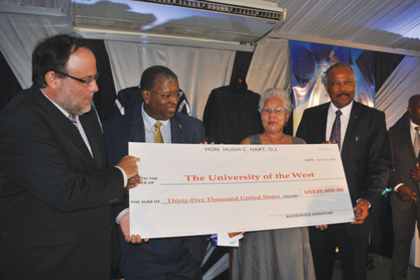 img:(l-r) Senator Mark Golding, an Oxford graduate; Donovan Walker, Partner, Hart, Muirhead & Fatta, Attorneys-at-Law; Lady McIntyre, wife of Sir Alister McIntyre and Sir Hilary Beckles, Vice-Chancellor of The University of the West Indies with the cheque for US$35,000 donated by Oxford graduate and Attorney-at-Law, Hugh Hart, to the McIntyre/Nettleford Scholarship Fund.