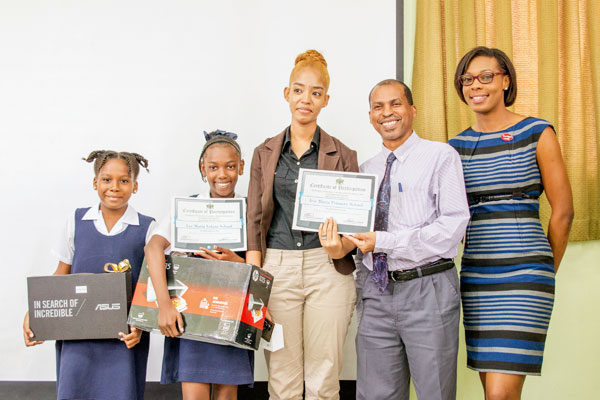 Image: Ms. Victor (right) with school winners