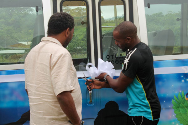 Image: (L-R) SLFA President Lyndon Cooper and Elite athlete Javelin thrower Albert Reynolds cut the ribbon commissioning St. Lucia team bus.