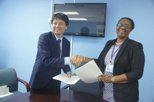 IMG: Mrs. Allison A.Jean, Permanent Secretary, Ministry of Infrastructure and Mr. Sakabe, leader of the preparatory survey team of JICA following the signing of the Minutes of Discussions.