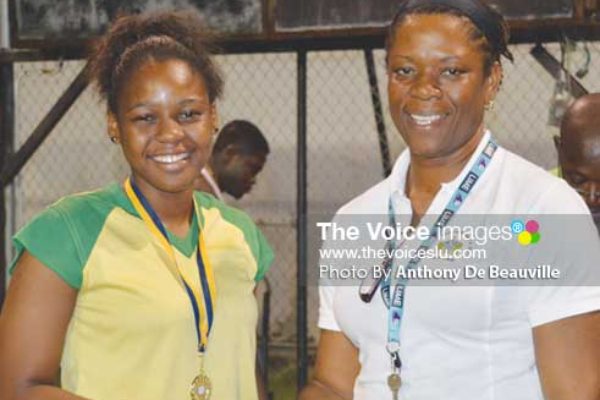 (L-R) SALCC Jedda Alcee receiving her gold medal from School Sports Coordinator Isabelle Marquis following the Secondary Schools Volleyballs finals between SALCC and SJC (Photo: Anthony De Beauville)