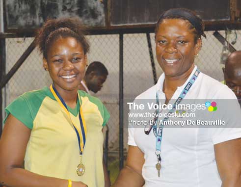 (L-R) SALCC Jedda Alcee receiving her gold medal from School Sports Coordinator Isabelle Marquis following the Secondary Schools Volleyballs finals between SALCC and SJC (Photo: Anthony De Beauville)