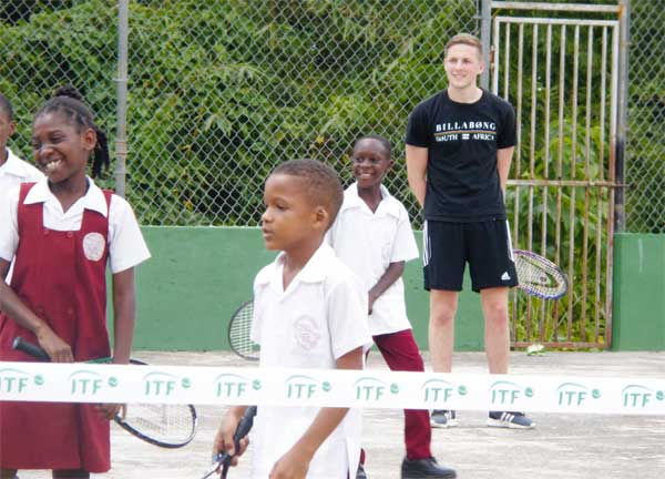 Image: Students getting tennis lessons.