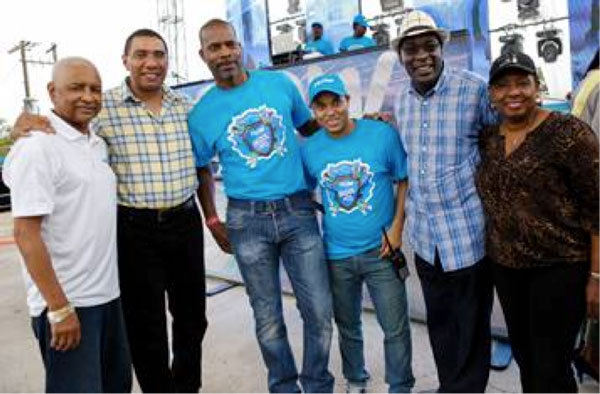 img: Prime Minister of Jamaica, The Most Honorable Andrew Holness (2nd left) is flanked by (from L- R) Errol Miller, Executive Chairman of the FLOW Foundation; Garry Sinclair, Managing Director, FLOW Jamaica; Carlo Redwood, VP Marketing & TV; the Hon. Senator Ruel Reid, Minister of Education, Youth and Information and the  Hon. Olivia Grange, Minister of Culture, Gender, Entertainment & Sport.