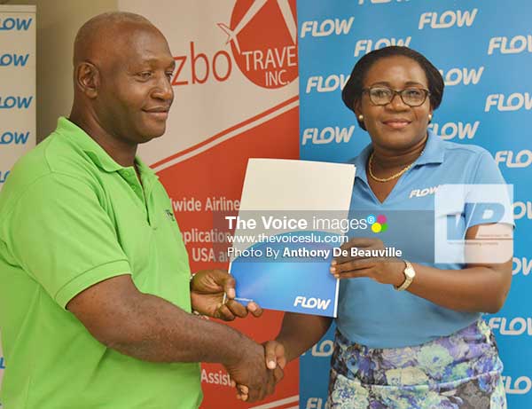 Image: (L-R) Best Coach, Vieux Fort South’s Emmanuel Bellas, receiving an award from FLOW representative Adriana Mitchel-Gideon. (Photo: Anthony De Beauville)  