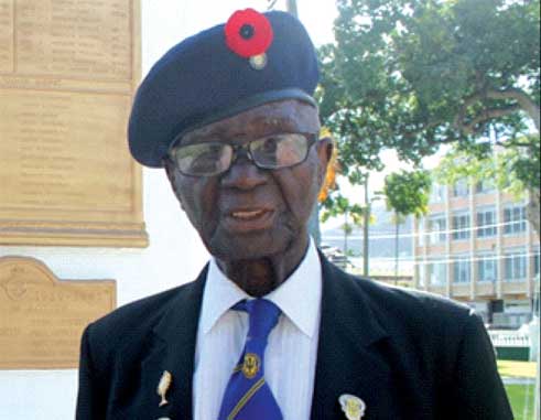 World War II veteran, Haynes Cyril, at the War Memorial in Derek Walcott Square. [Photo: Stan Bishop]