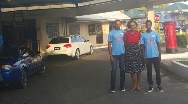 img: Digicel's Louise Victor sees Jervel Tobierre and Nyrone Winter off as they depart for Manchester City.