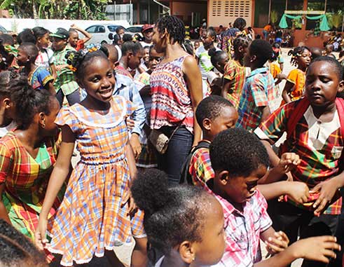Image: Students of the Gordon and Walcott Memorial School in Castries (left) and Grace Combined in Vieux Fort (right) in the thick of JounenKweyol activities yesterday.