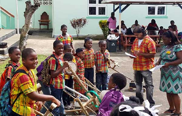 Image: Students of the Gordon and Walcott Memorial School in Castries (left) and Grace Combined in Vieux Fort (right) in the thick of Jounen Kweyol activities yesterday.