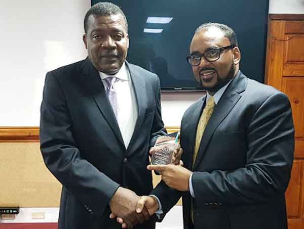 Image: CCRIF CEO, Mr. Isaac Anthony (right) presents a memento symbolizing payouts of US$23.4 million to Hon. Yves Bastien, Haiti’s Minister of Finance at a ceremony on November 7, 2016. The payouts were due on Haiti’s tropical cyclone and excess rainfall policies due to Hurricane Matthew and payment was paid 14 days after the event on October 17, 2016.