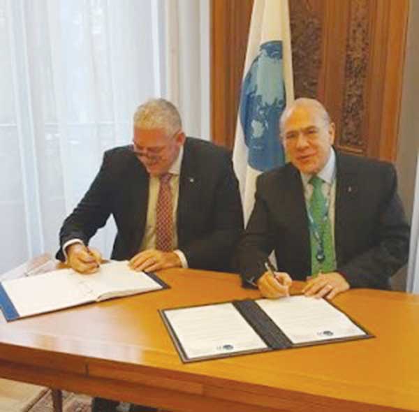 Image: Prime Minister Chastanet signing the agreement in Paris