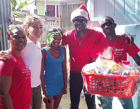 Image: Digicel Country Manager and Brand ambassadors gifts single mother.