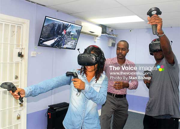 Image: Jano James (centre) supervising two gamers enjoying the VR experience. [PHOTOS: Stan Bishop]