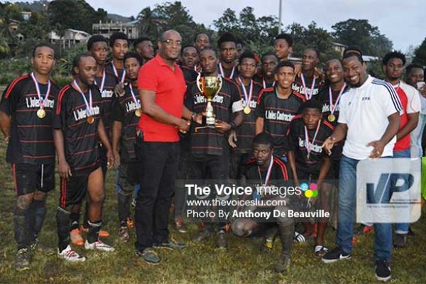 Image: Parliamentary Representative for Dennery North, Shawn Edward, presenting Survivals captain with the 2016 championship trophy . (PHOTO: Anthony De Beauville)