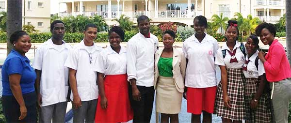 Image of Chef Mark (centre) flanked by students and teachers.