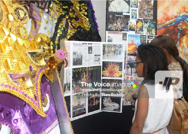 Image: Patrons get a glimpse into the art of the masquerade by Giovanni  St. Omer. [PHOTO: Stan Bishop]