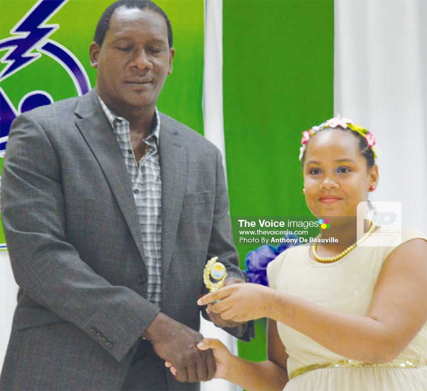 Image: Parliamentary representative for Gros Islet Lenard Montoute presenting Angelique Gaillard with her award. (Photo: Anthony De Beauville)