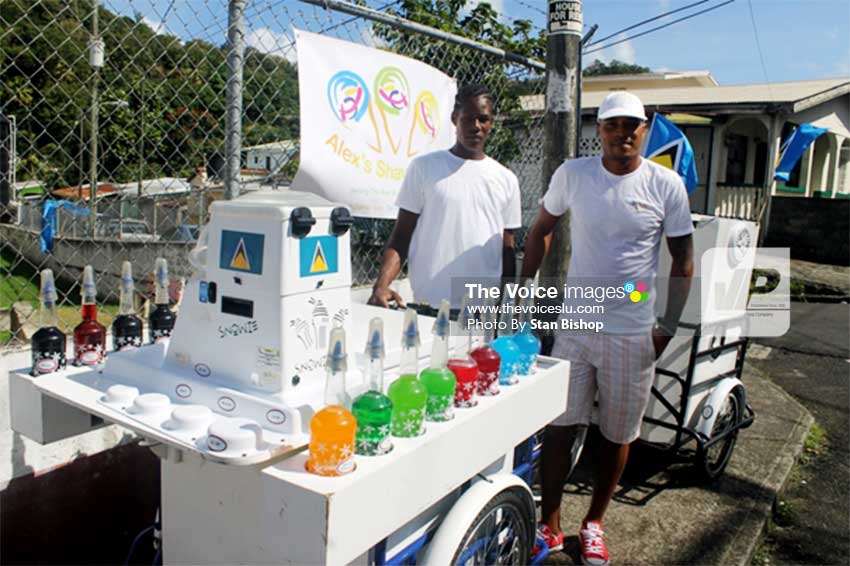 Image: David Alexander Growth (right) and his assistant, Jeanmal, with their sno cone cart in La Clery. [PHOTO: Stan Bishop]