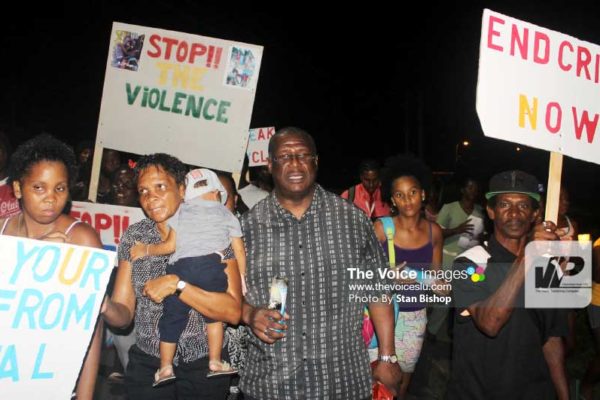 Image: Castries North MP, Stephenson King, leading the candlelight vigil and silent march last Tuesday evening in La Clery. [PHOTO: Stan Bishop]