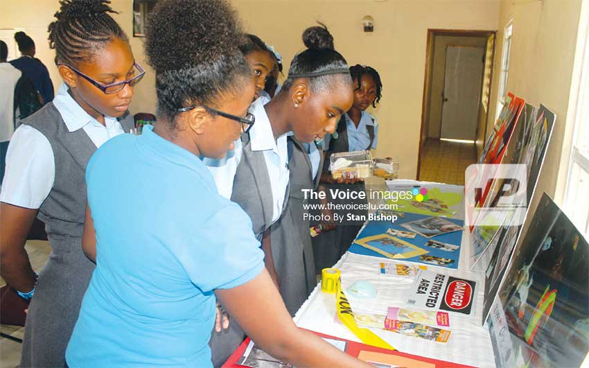Image: A YEAC member explains to students various aspects of their operations.   [PHOTO: Stan Bishop]