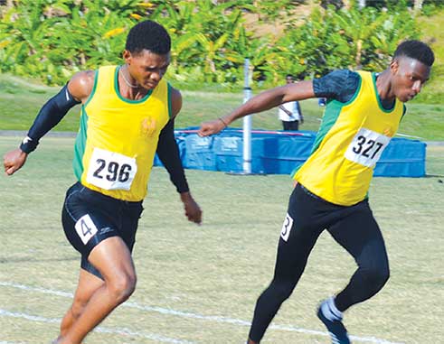 Image: (Left) Choiseul Secondary Jeanmeachel Etienne and Kenneth Verneuil in epic finish in the boys under 18 - 200 metres final; (right) Kimani Alphone of Vieux Fort Comprehensive wins the girls under 18 - 200 metres finals. (PHOTO: Anthony De Beauville)