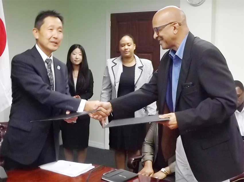 Image: The exchange of documents for the purchase of  the ambulance between St. Jude Hospital Board Chairman, Dr. Ulric Mondesir and Japanese Ambassador  Mr. Mitsuhiko Okada