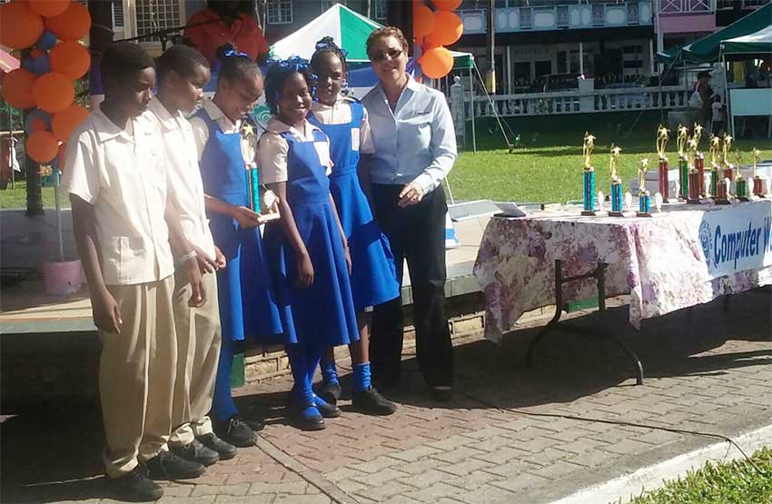 iMAGE: Students pose with Bank of Saint Lucia official, Maria Fowell.