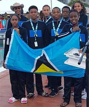 Image: Naima Hazel carrying the Saint Lucia flag with teammate Mikaili Charlemagne. (PHOTO: LASC) 