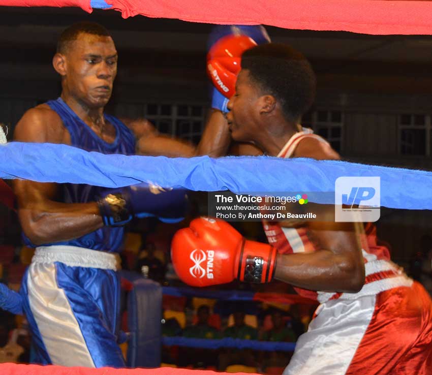 Image: Saint Lucia’s Marvin Anthony (in blue) and Barbados’ Ision Fraser battle it out. (Photo: Anthony De Beauville)